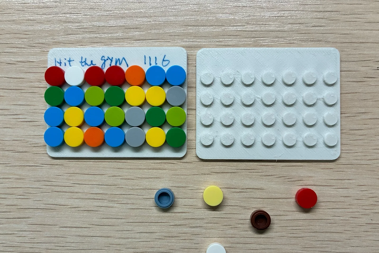 A completed baseplate and an empty baseplate sit side by side on Louis's desk.